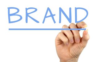 Hand writing 'Brand' – 6 tips for creating a strong brand