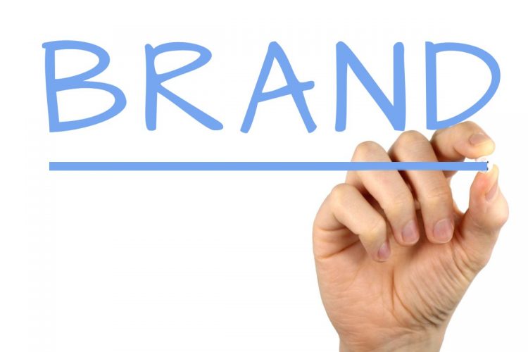 Hand writing 'Brand' – 6 tips for creating a strong brand